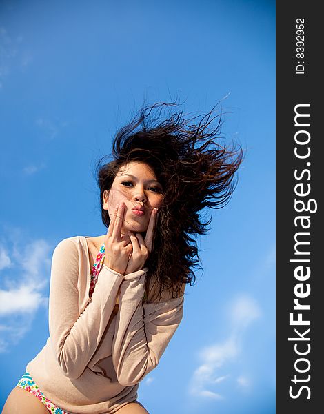 Happy young woman with blue sky