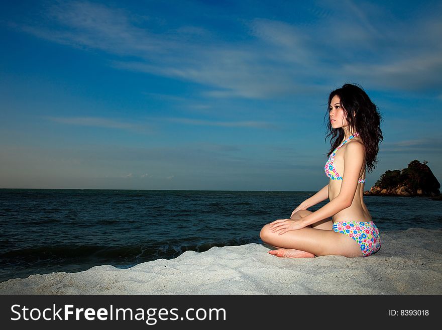 Young woman relaxing by the summer beach. Young woman relaxing by the summer beach