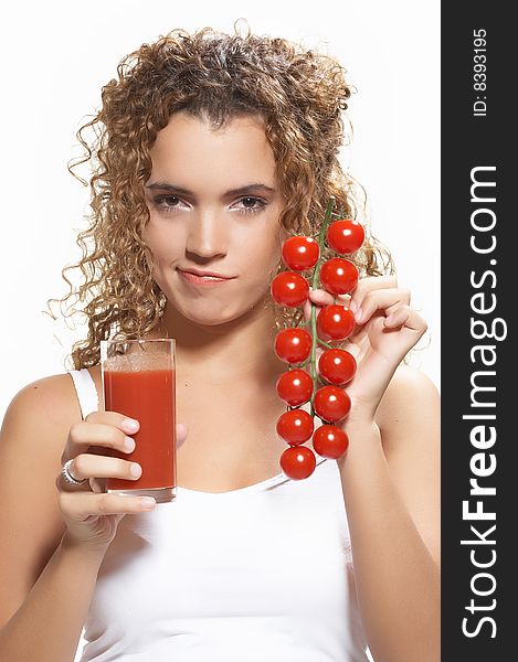 Half body portrait of young woman holding glass of tomato juice and tomatoes on vine, isolated on white background. Half body portrait of young woman holding glass of tomato juice and tomatoes on vine, isolated on white background.