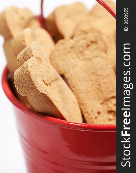 Closeup of brown dog treats in a red bucket. Closeup of brown dog treats in a red bucket.