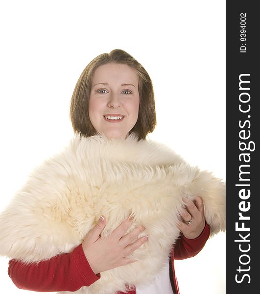 A young woman with a nice smile holding a white fur. A young woman with a nice smile holding a white fur