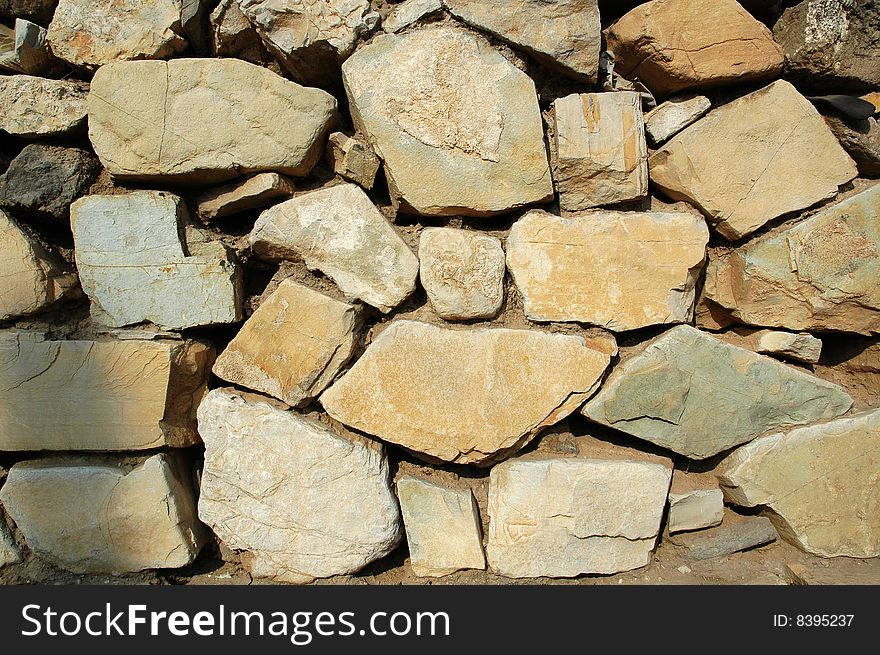The old stone masonry wall. The old stone masonry wall