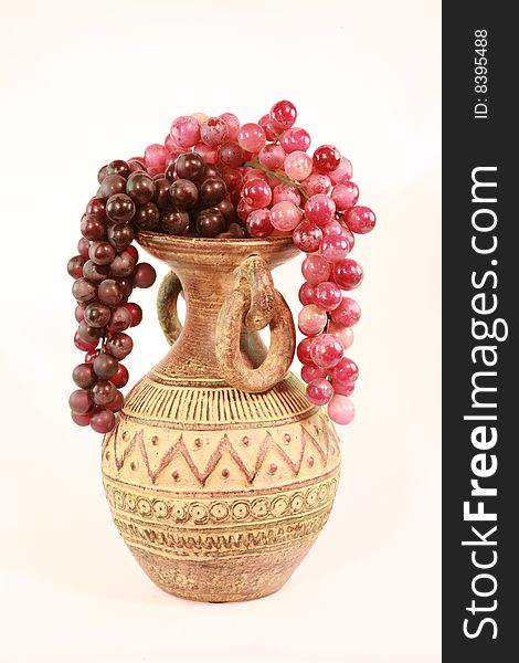 An array of grape over a vase. An array of grape over a vase