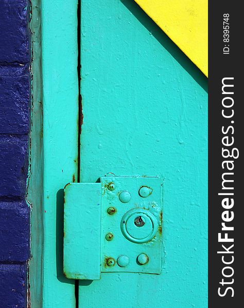 Colorful exterior door lock on an urban building.