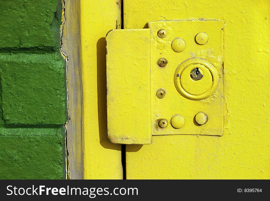 Yellow exterior door lock on an urban building. Yellow exterior door lock on an urban building.