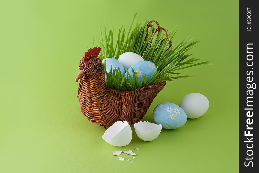 Easter eggs and basket with green grass. Easter eggs and basket with green grass