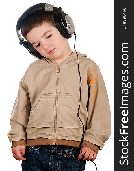 Boy listening to music on headphones isolated on white. Boy listening to music on headphones isolated on white.