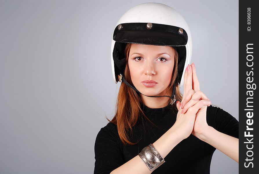 Young beautiful woman in black clothes and white helmet. Young beautiful woman in black clothes and white helmet