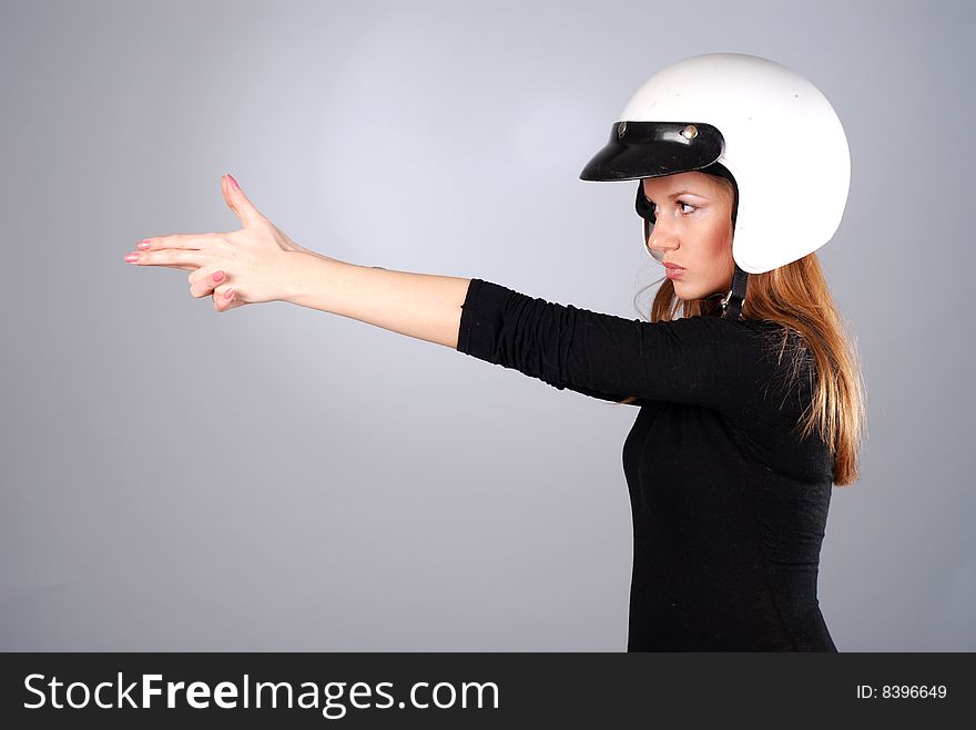 Young beautiful woman in black clothes and white helmet. Young beautiful woman in black clothes and white helmet