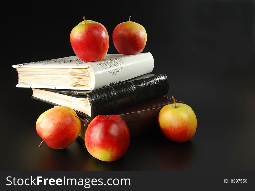 Apples and albums on a black background