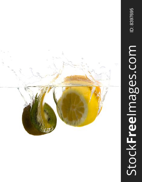 Big green kiwi and lemon splashing in water. Big green kiwi and lemon splashing in water