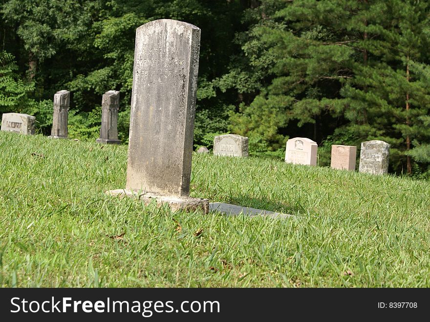 Century old headstones in a graveyard in the Smokey Mountains of Tennessee. Century old headstones in a graveyard in the Smokey Mountains of Tennessee.