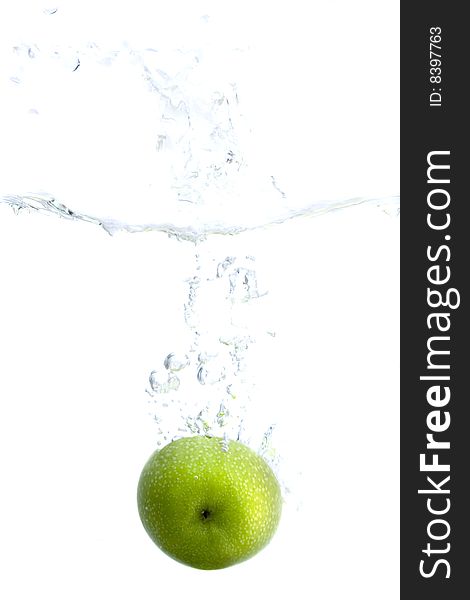 Big green apple splashing in water