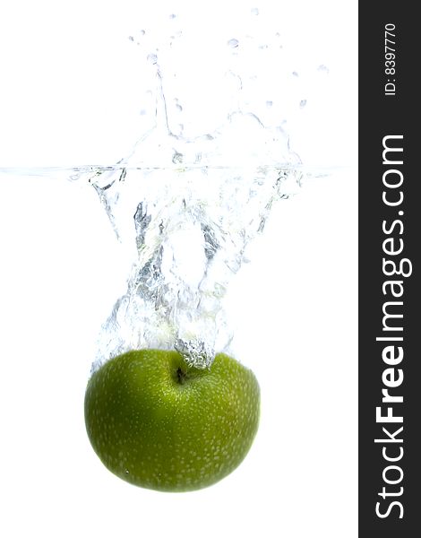 Big green apple splashing in water