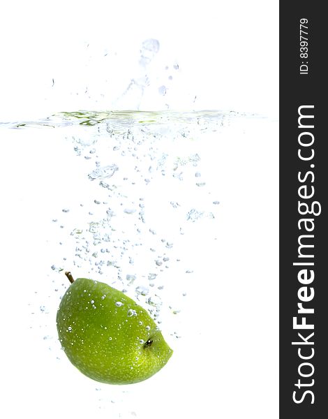 Big green apple splashing in water