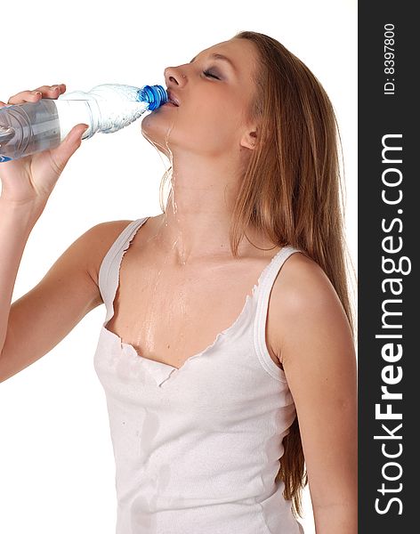 Woman in wet white shirt with bottle of water. Woman in wet white shirt with bottle of water