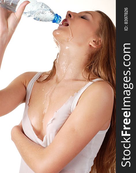 Woman in wet white shirt with bottle of water. Woman in wet white shirt with bottle of water