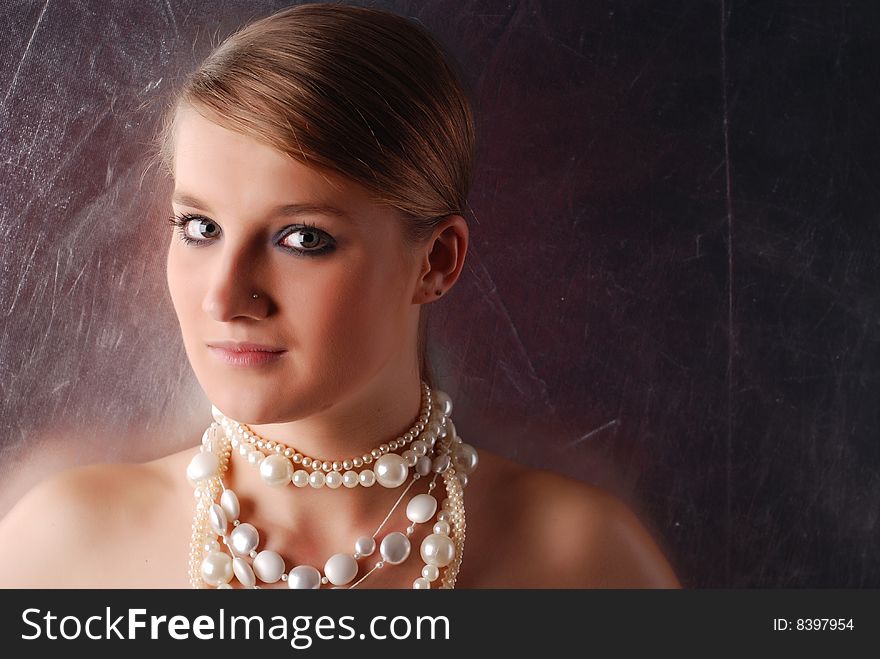 Portrait of a young beautiful woman with necklace