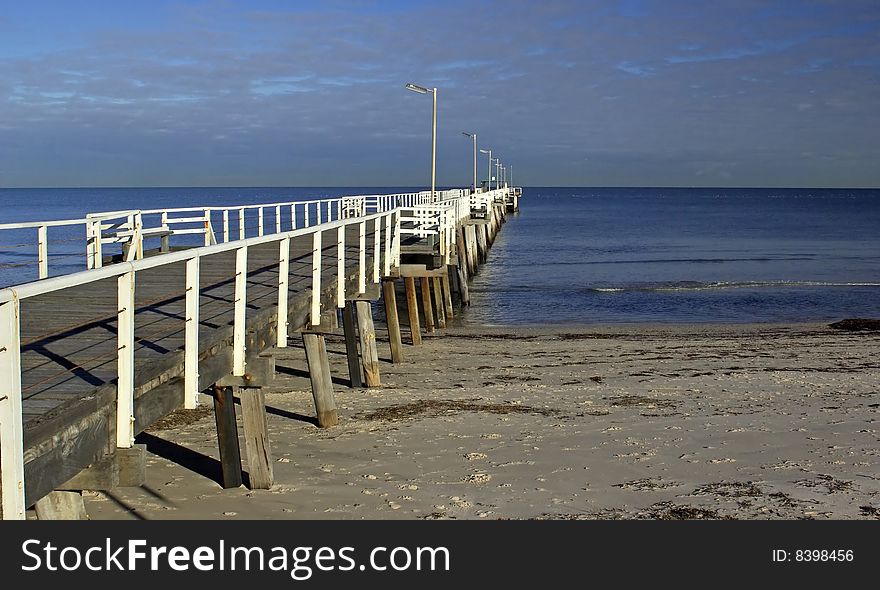 A shot of a beach with a jetty going off into the distance. A shot of a beach with a jetty going off into the distance.