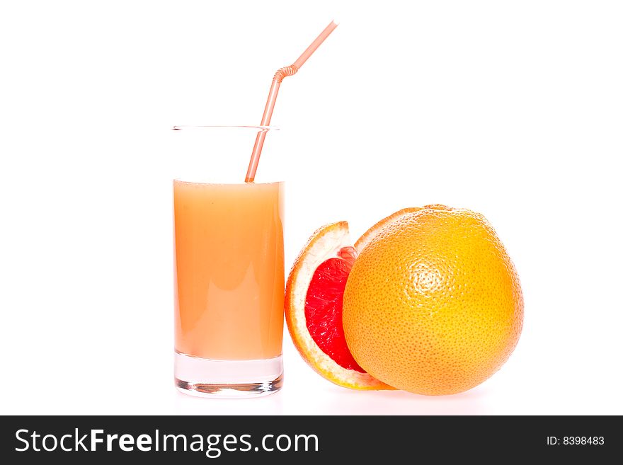 Grapefruit and juice in glass on a white background