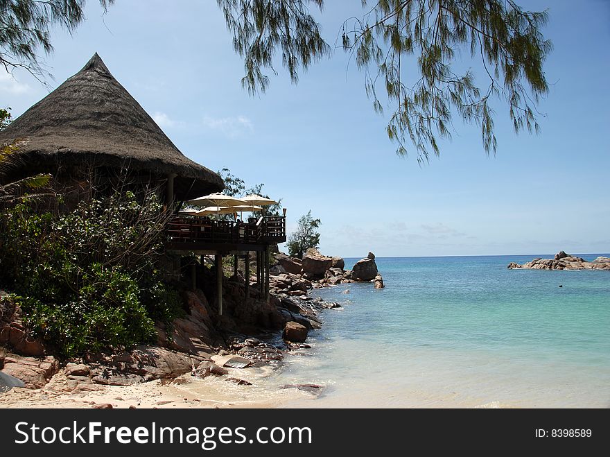 Seychelles stones and palm trees on the bank of azure ocean. Seychelles stones and palm trees on the bank of azure ocean