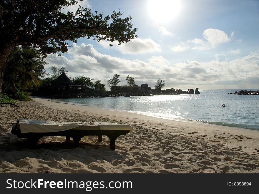 Seychelles stones and palm trees on the bank of azure ocean. Seychelles stones and palm trees on the bank of azure ocean