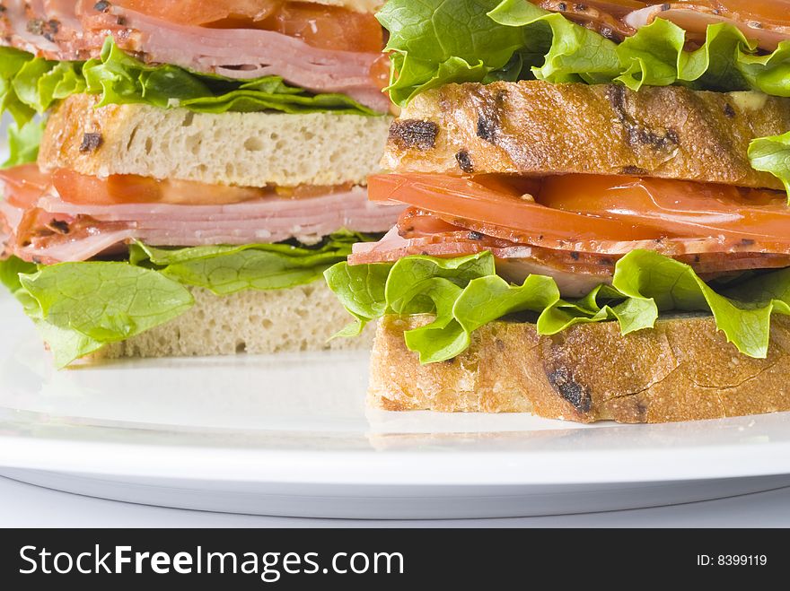 Closeup of pastrami sandwich isolated on white.