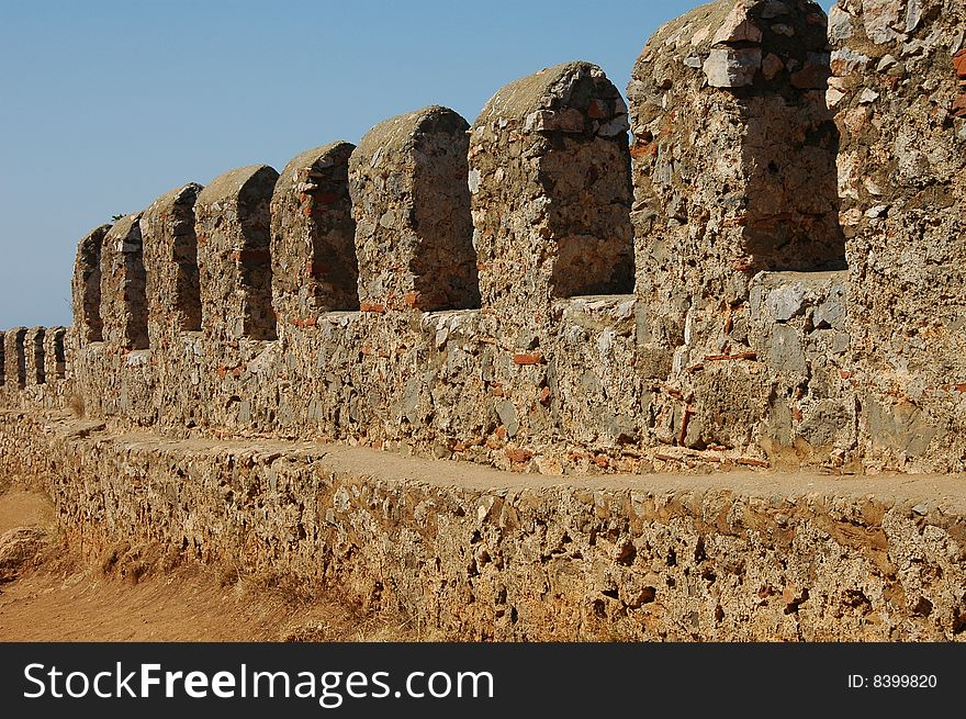 Old wall. Blue sky. Stones.