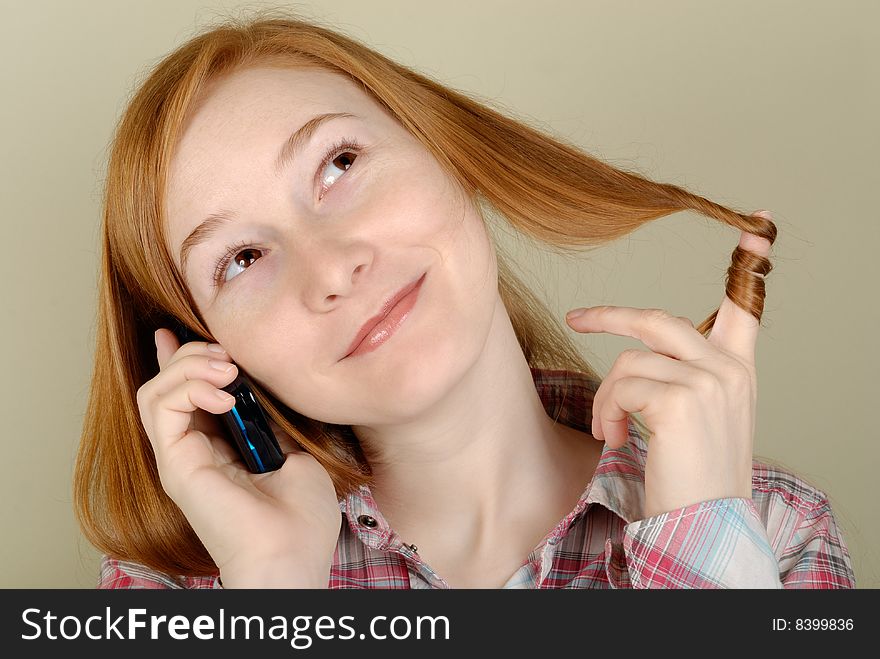 Redhead young woman speaks on the mobile phone