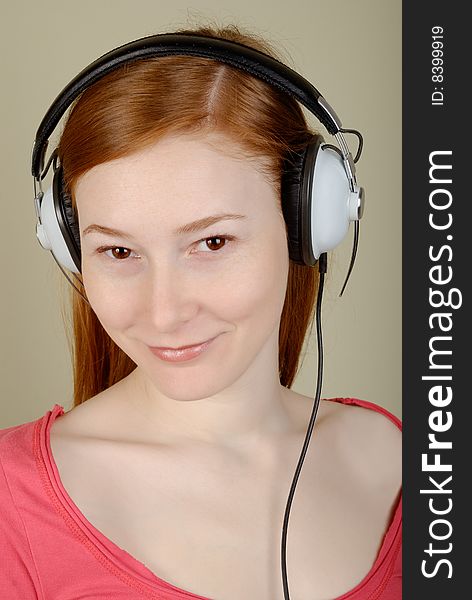 Redhead young woman in headphones