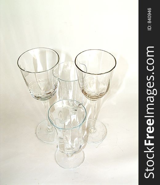 Tranparent wine glasses on light creamy background. Tranparent wine glasses on light creamy background