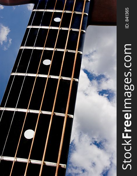 Guitar details with clouds background