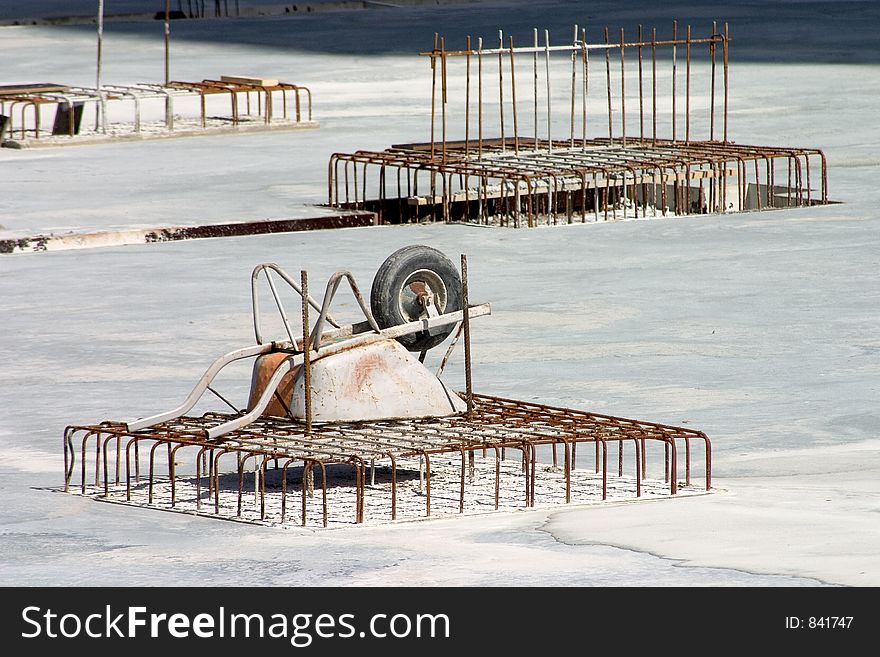 Wheelbarrow sitting upside-down on rebar. Wheelbarrow sitting upside-down on rebar