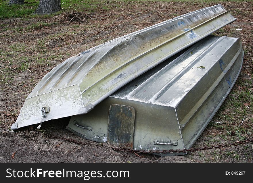 Two abandoned paddle boats upside down. Two abandoned paddle boats upside down