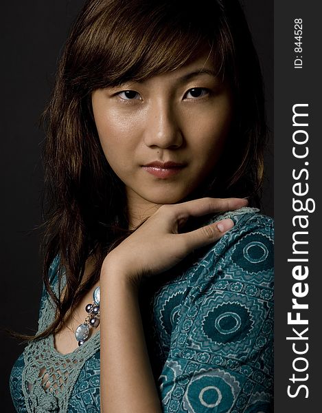 An attractive young asian woman on black background. An attractive young asian woman on black background