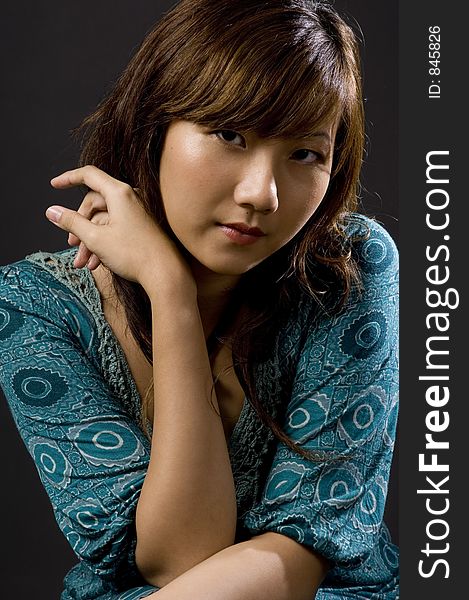 A pretty young asian woman on black background