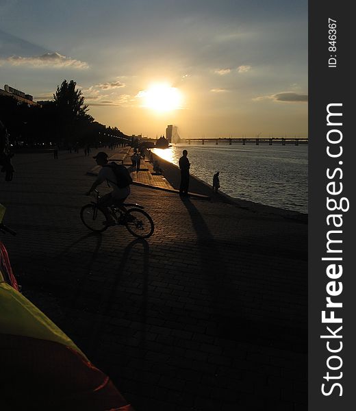 Biker on the sunset in Dniepr bay. Biker on the sunset in Dniepr bay