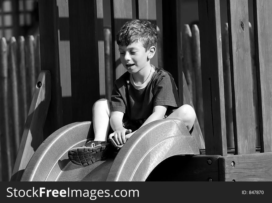 Young Boy on a Slide. Young Boy on a Slide