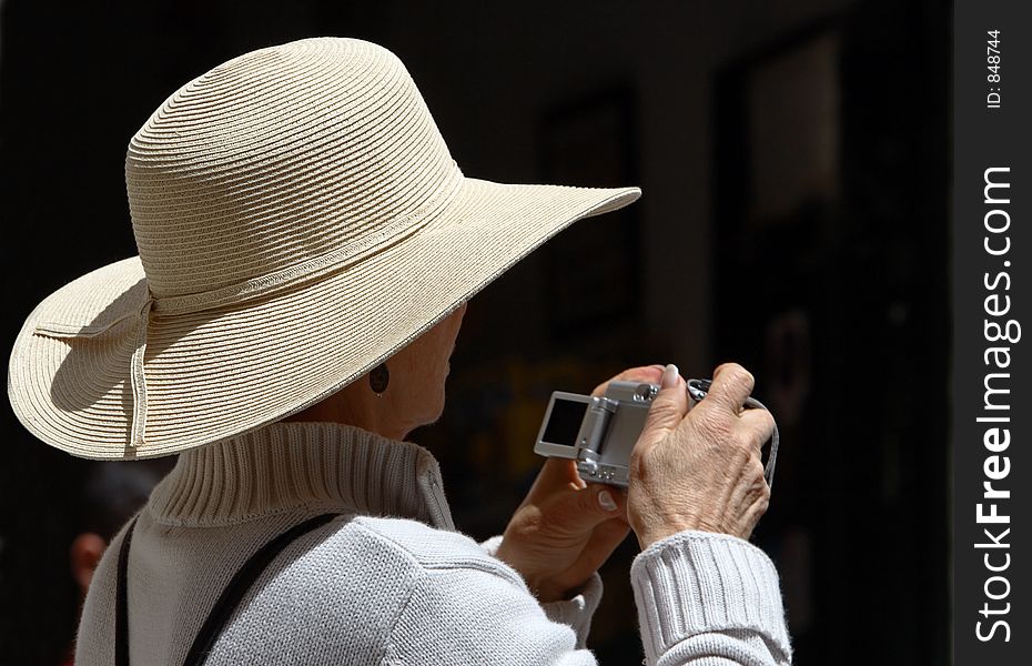 Woman wearing hat with digital camera. Woman wearing hat with digital camera