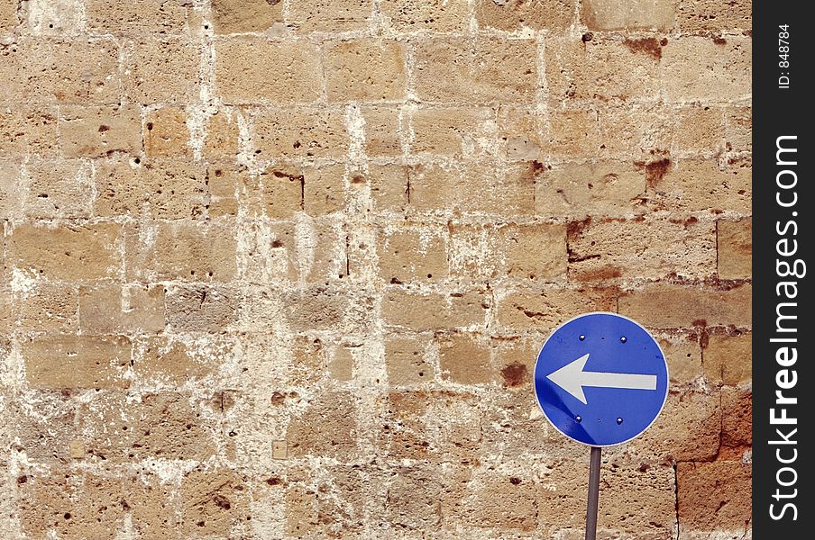 Road sign with the brick wall in the background. Road sign with the brick wall in the background