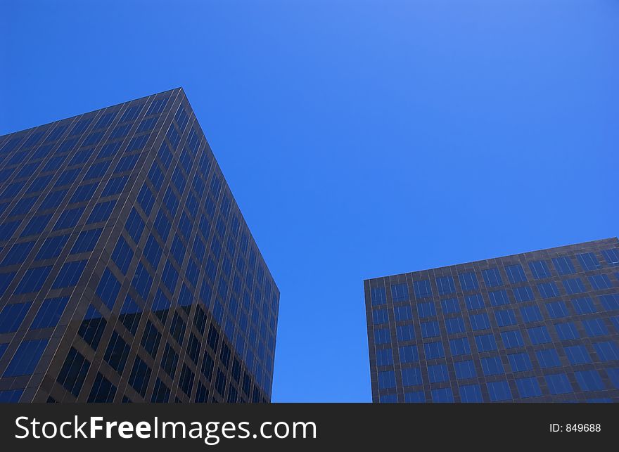 Two corporate buildings and blue sky