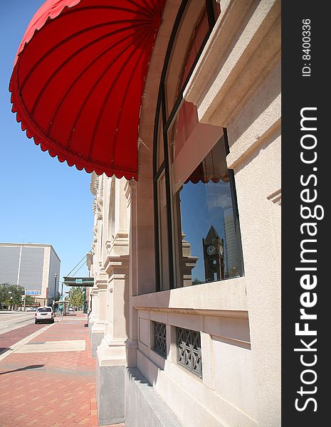 Red Parasol Shading Window with Reflection of Houston Clock Tower