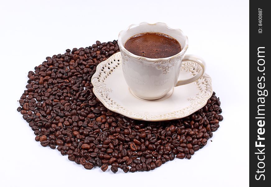Cup of coffee and whole coffee beans isolated on white background. Cup of coffee and whole coffee beans isolated on white background