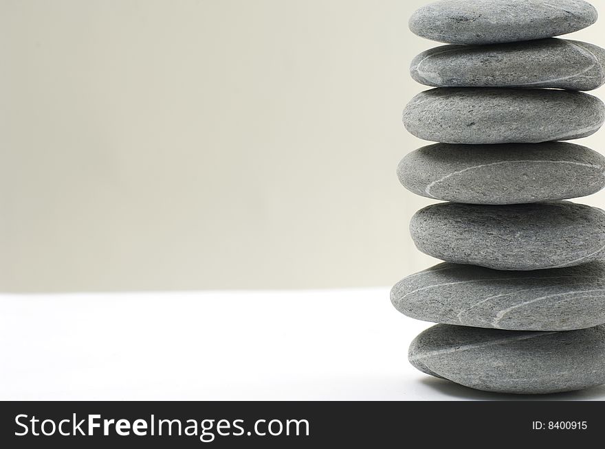 An isolated balanced stone on white