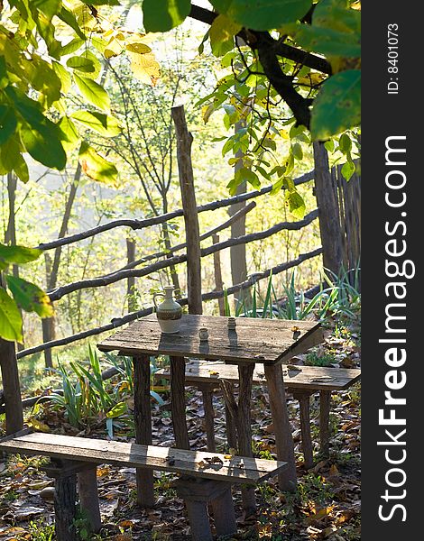 Rustic table with water pot in morning sun