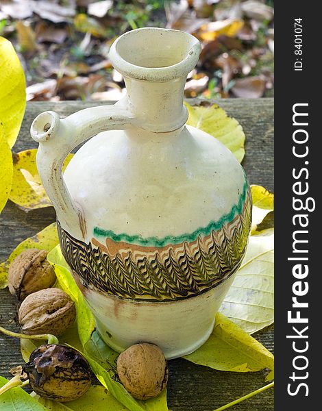 Water pot with nuts and leafs