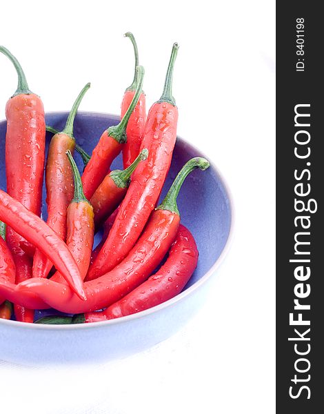 A bowl of red chilli peppers isolated on white. A bowl of red chilli peppers isolated on white