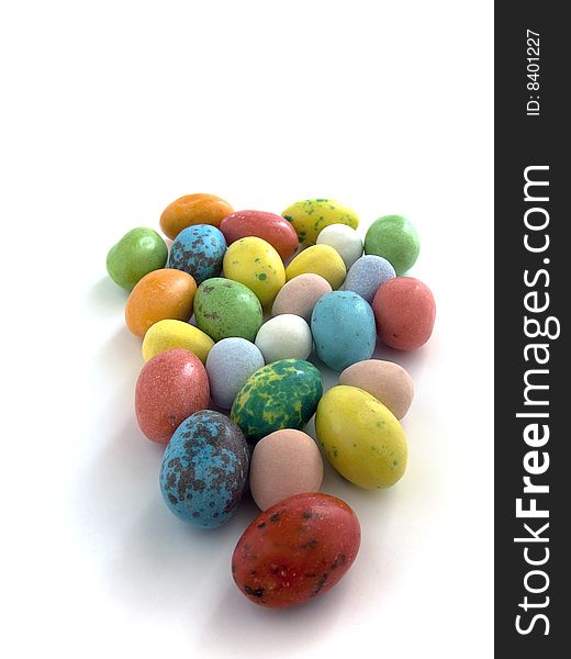 Candy coated chocolate easter eggs on white background