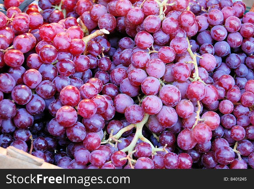 This is a shot of a fruit stand display of grapes.