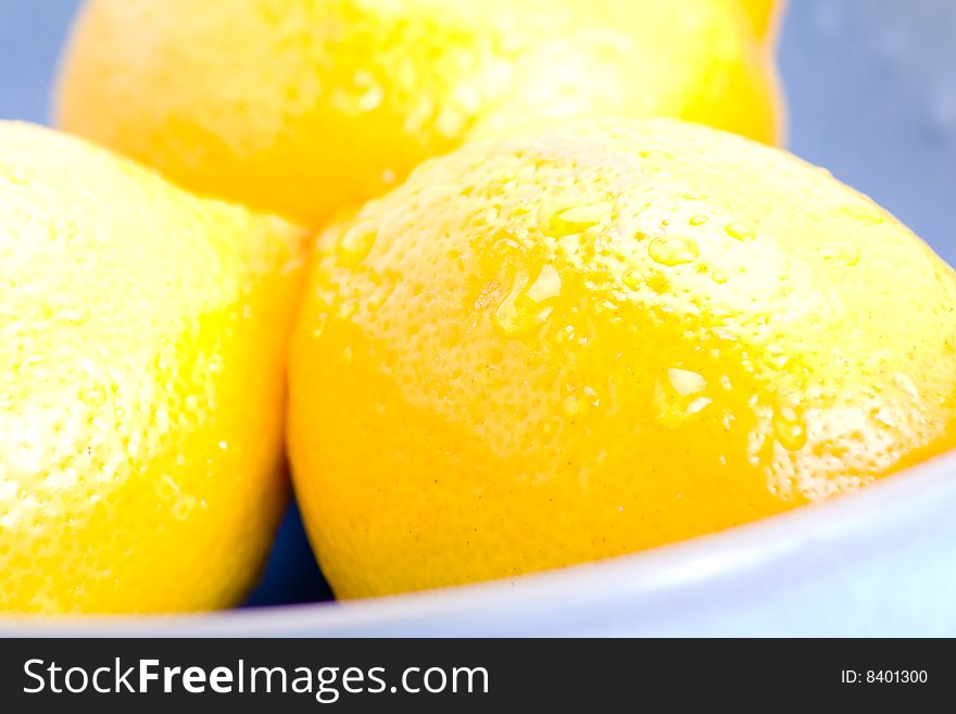 Detail of fresh lemons in a blue bowl